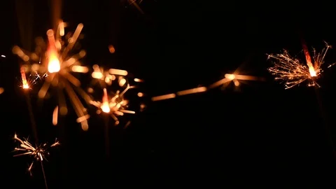 Sparklers burn on a black background Stock Footage 121114584