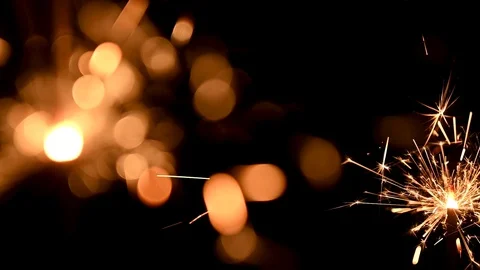 Sparklers burn on a black background Stock Footage 121114641