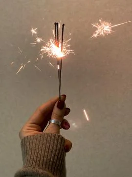 Sparklers in hand on a simple background Fotos Stock