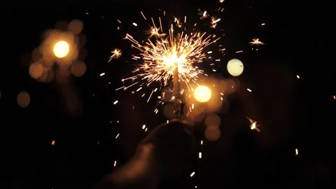 Sparklers in the hands of a man Stock Footage 142156986