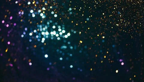 Sparkles multicolored shining on a dark background. Template for creative Stock Photos