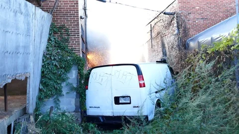 Sparkling and flames during building fire in alley Stock Footage 119862973