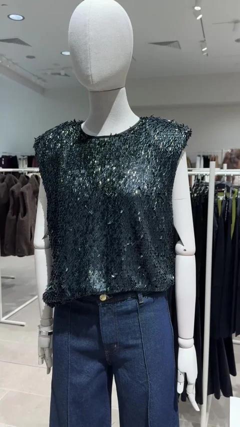Sparkling Black Sequin Top Styled With Jeans On Mannequin Display Stock Footage 344977652