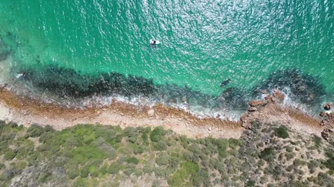 Sparkling Blue Ocean with Cliffs and Boat Stock Footage 297120498