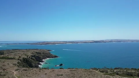 Sparkling Blue Ocean with Cliffs and Boat Video stock 297121471