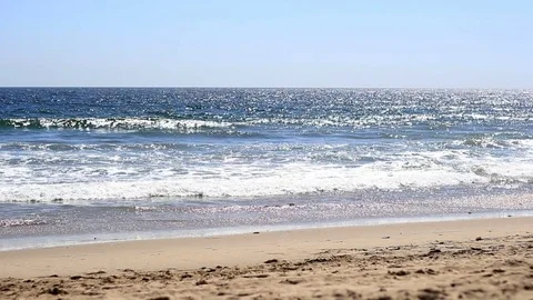 Sparkling blue ocean waves on empty beach Stock Footage 76666163