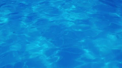 Sparkling blue pool water surface with rippling light patterns Stock Footage 341389249