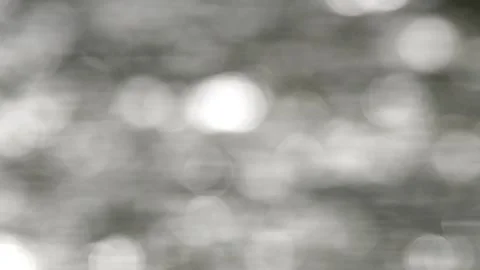 The sparkling bokeh of flowing river water 스톡 동영상 336829470