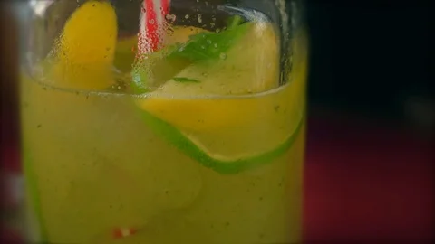 Sparkling bubbles water with a slice of lime. Slow motion macro footage. Stock Footage 74053103