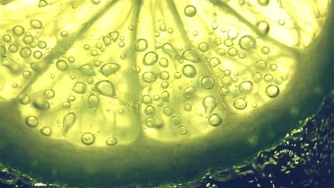 Sparkling bubbles water with a slice of lime Stock Footage 81356173