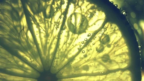 Sparkling bubbles water with a slice of lime Stock Footage 81376485