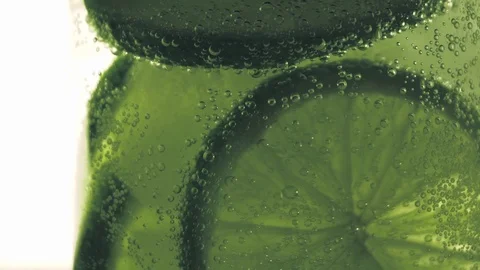 Sparkling bubbles water with a slice of lime Stock Footage 111495196