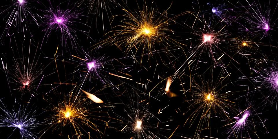 Sparkling burning sparkler on a black background. Stock Photos