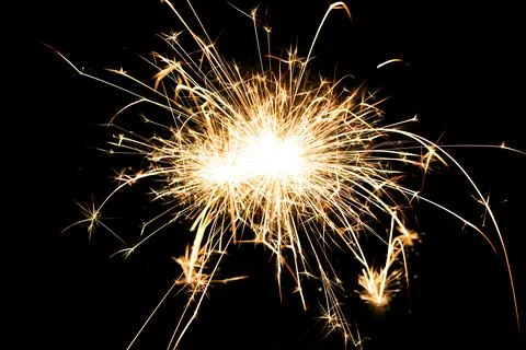 Sparkling burning sparkler on a black background. Stock-Fotos