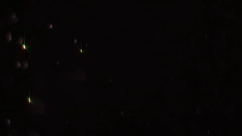 Sparkling dust particles falling on blac... | Stock Video | Pond5