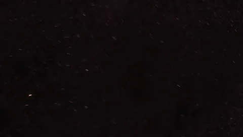 Sparkling dust particles falling on blac... | Stock Video | Pond5