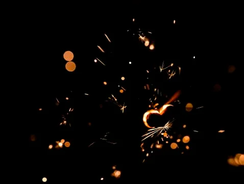 Sparkling fire with a heart shape Stock Photos
