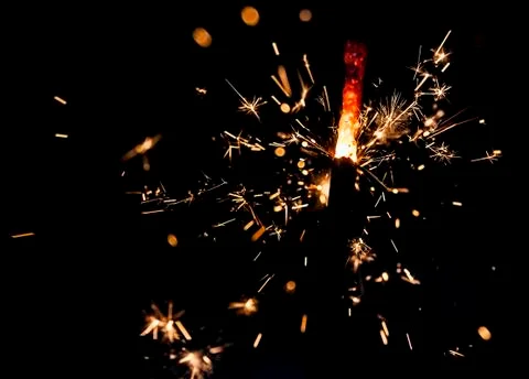Sparkling fire stick with particles Stock Photos