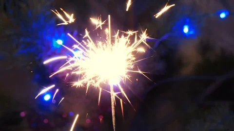 Sparkling firework stick burning in the sark until it extinguishes. colorful lig Stock Footage 102281009