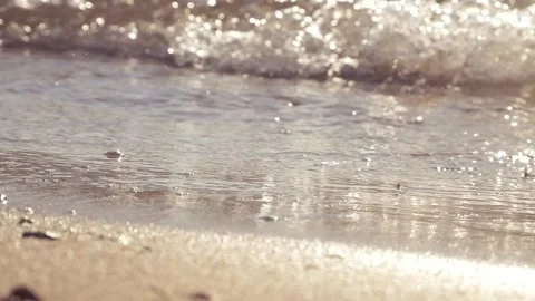 Sparkling gentle ocean waves wash onto a sunny sandy beach. Stock Footage 337408386