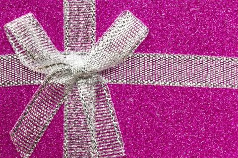 Sparkling gift box or present with bow ribbon on magic Background with glitters Stock Photos