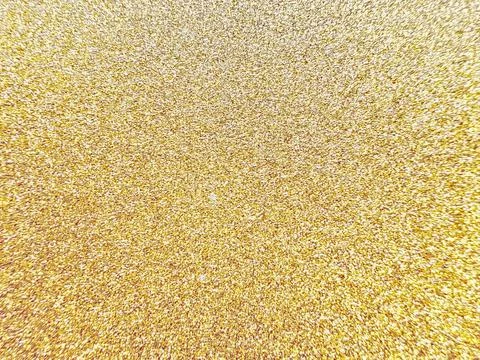 Sparkling gold glitter texture background with shimmering metallic dust parti Stock-Fotos