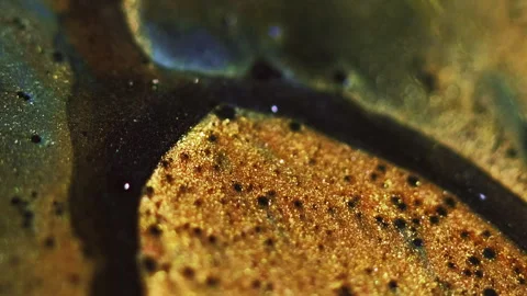 Sparkling ink spill bokeh light golden black wave Stock Footage 288274350