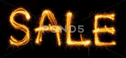 Sparkling inscription of SALE on a black Stock Photos