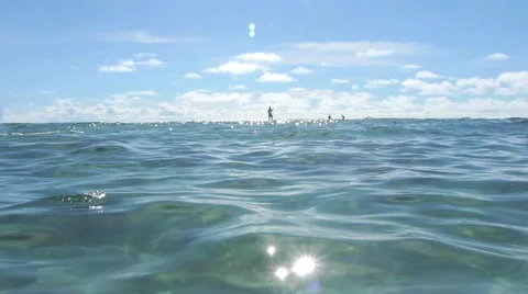 Sparkling Light on Ocean with Paddler Stock Footage 1055359