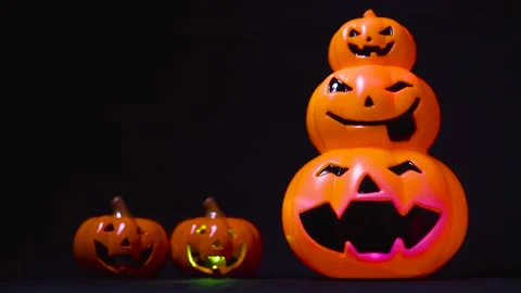 Sparkling Light Overlap Pumpkins Face in Black Background Stock Footage 153585630