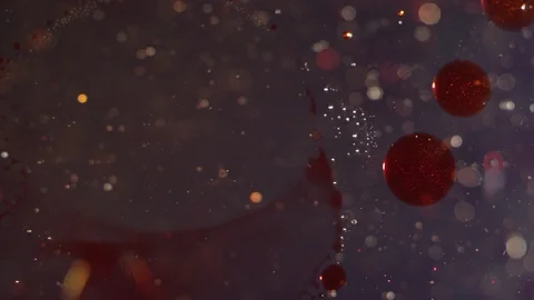 Sparkling liquid blood red bubbles moving together bokeh texture background Video stock 118287072