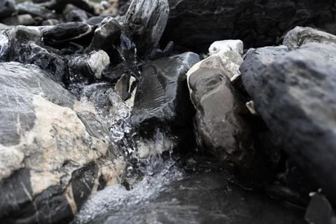 Sparkling mountain stream close up view . natural fresh water is coming out.. Stock Photos
