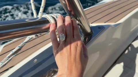 Sparkling oval diamond ring captured during sunny Mediterranean cruise Stock Footage 319406897