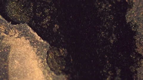 Sparkling paint ink drip golden black mixing flow Stock Footage 287943379