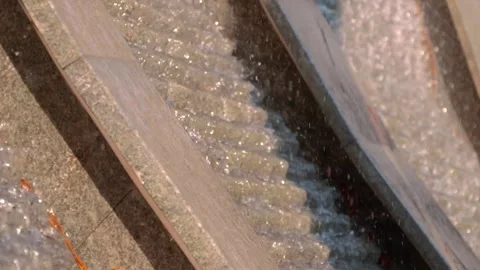 Sparkling in the rays of the sun, the waterfall flows down a vertical wall  Stock Footage 323836826