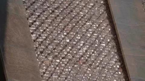 Sparkling in the rays of the sun, the waterfall flows down a vertical wall Stock Footage 323902761