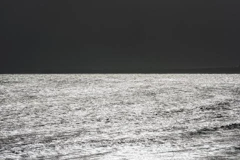 Sparkling reflection of sunlight on the sea surface Stock Photos