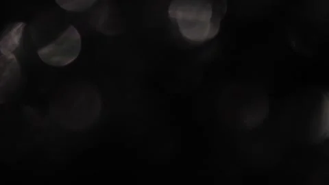 Sparkling silver bokeh stands out against the black of the screen. 動画素材 317482223