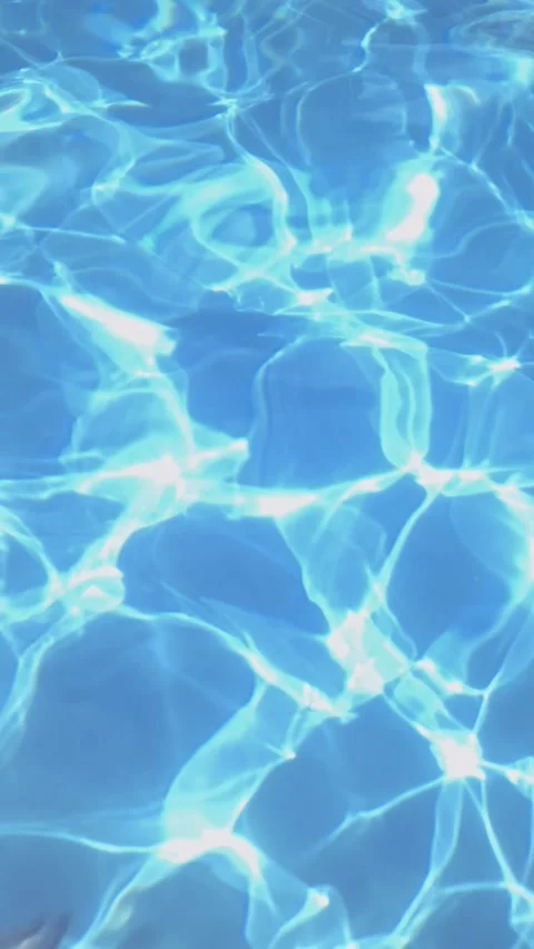 Sparkling Sunlight Reflections on Clear Blue Swimming Pool Water Surface Video stock 339085873