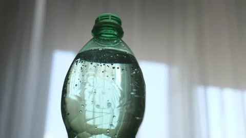 Sparkling water with bubbles. bubbles in soda water bottles. carbonated water Stock Footage 197109054