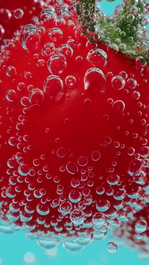 Sparkling water bubbles clinging to ripe strawberry fruit underwater in vertical Stock Footage 346640001