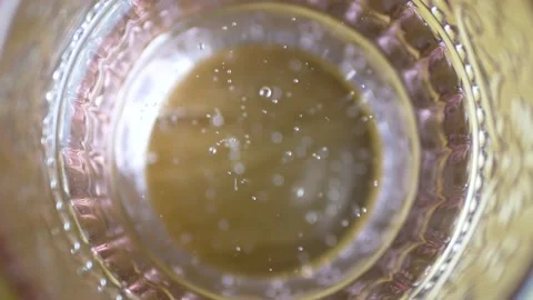 Sparkling water Bubbles in a glass seeing from above Stock Footage