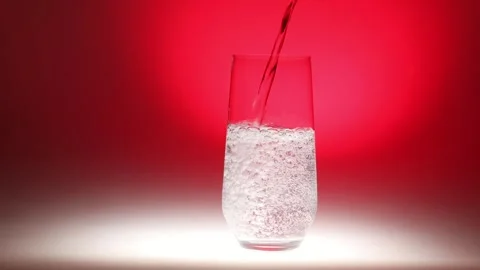 Sparkling Water Bubbles on Red Backdrop Stock Footage 256764578