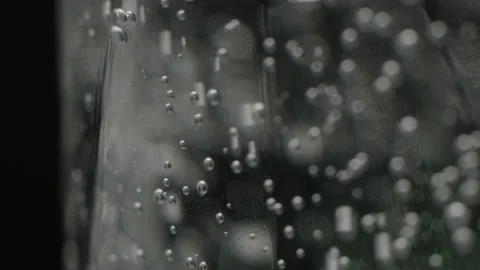 Sparkling water in the glass bubbles going up slow-mo motion Stock Footage 159759712