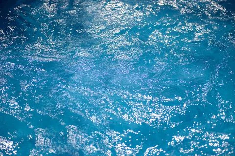 Sparkling water surface in the pool in the sun, summer minimalistic calm Stock Photos