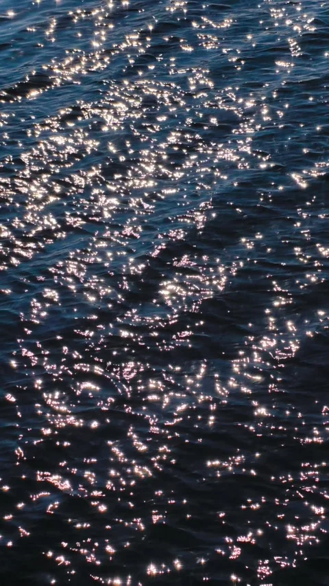 Sparkling Water Surface with Sunlight Reflections Vertical Cinematic Slow Motion Stock Footage 318549597