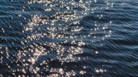 Sparkling Water Surface with Sunlight Reflections. Cinematic Slow Motion 4K  Stock Footage 318549609