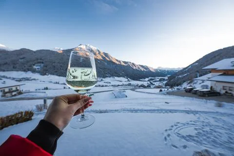 Sparkling white wine toast frames Dolomite Mountains in South Tyrol Stock Photos