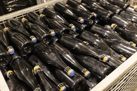 Sparkling wine bottles resting in fermentation racks in Havraniky Stock Photos