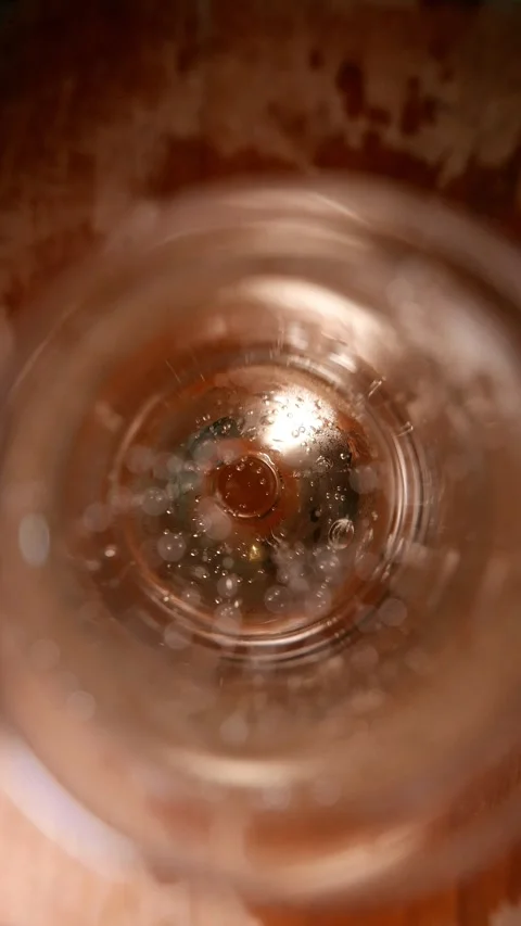 Sparkling wine bubbles rise in a flute glass (top view, close-up). Champagne 스톡 동영상 346794670